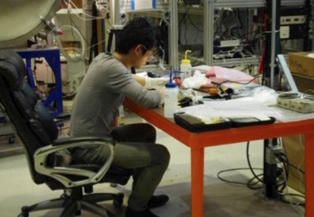 Osamu prepares the detector before installing in the testing chamber